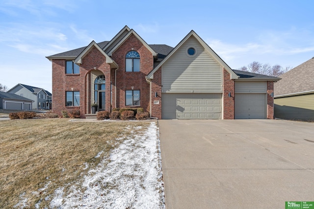 view of front property featuring a garage and a front yard