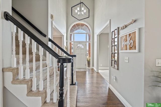 foyer featuring a notable chandelier, hardwood / wood-style floors, and a high ceiling