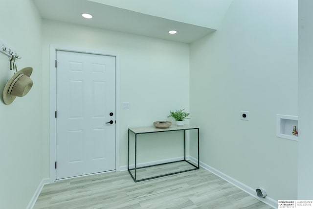 interior space with washer hookup, light hardwood / wood-style floors, and hookup for an electric dryer