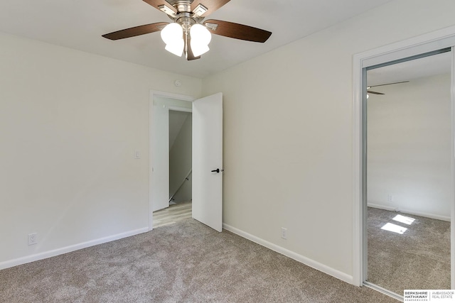 unfurnished bedroom with ceiling fan and light carpet