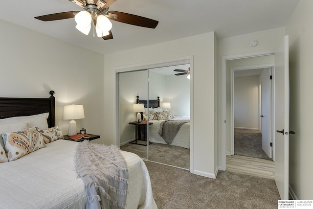 bedroom featuring light carpet, ceiling fan, and a closet