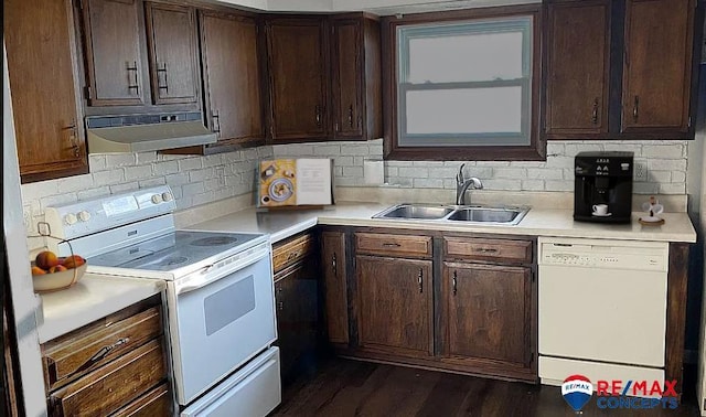 kitchen featuring white appliances, dark brown cabinetry, dark hardwood / wood-style flooring, and sink