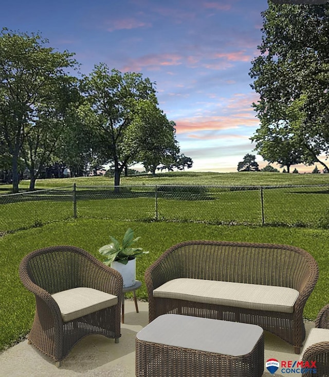 patio terrace at dusk with a yard and a rural view