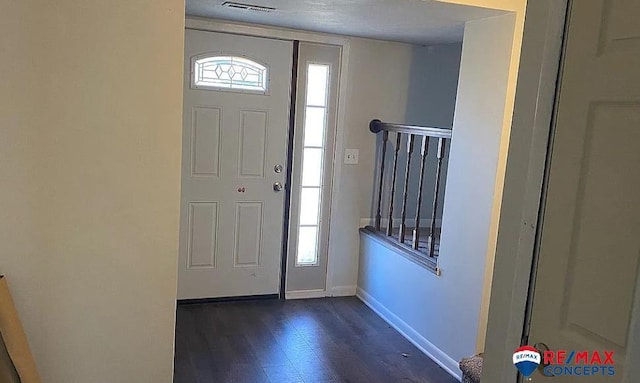 entrance foyer featuring dark hardwood / wood-style floors and a healthy amount of sunlight