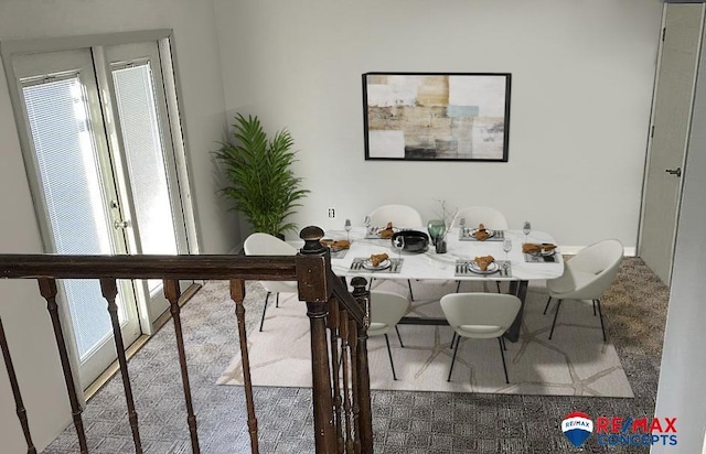 dining room featuring plenty of natural light and carpet