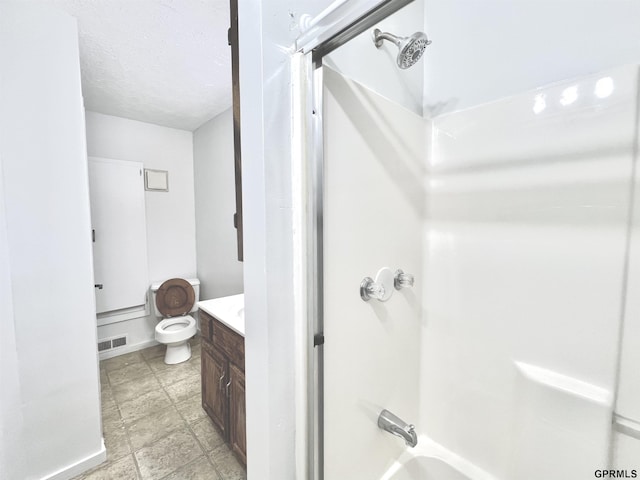 full bathroom featuring vanity, toilet, bathing tub / shower combination, and a textured ceiling