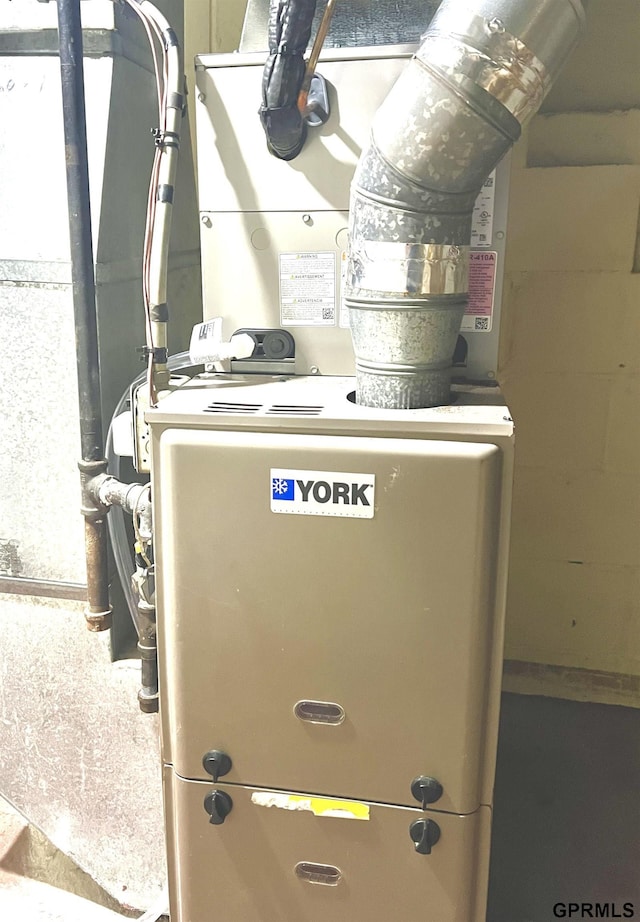 utility room featuring heating unit