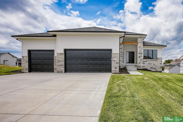 prairie-style home with a garage and a front lawn