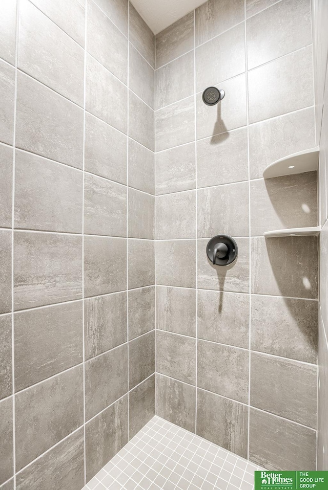 bathroom with a tile shower