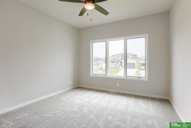 carpeted spare room featuring ceiling fan