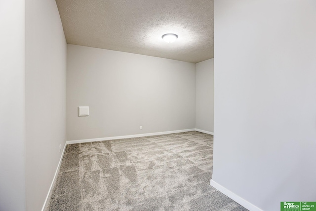 unfurnished room featuring a textured ceiling and carpet flooring