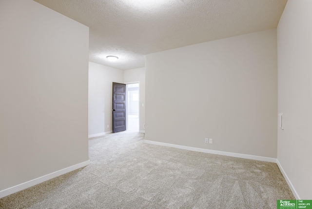 carpeted spare room featuring a textured ceiling