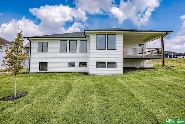 rear view of house featuring a wooden deck and a yard