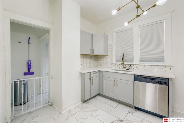 kitchen featuring stainless steel dishwasher, gray cabinets, sink, and decorative backsplash