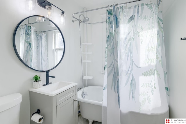 full bathroom with vanity, shower / tub combo, and toilet