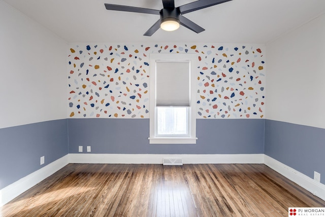 empty room featuring ceiling fan and hardwood / wood-style floors