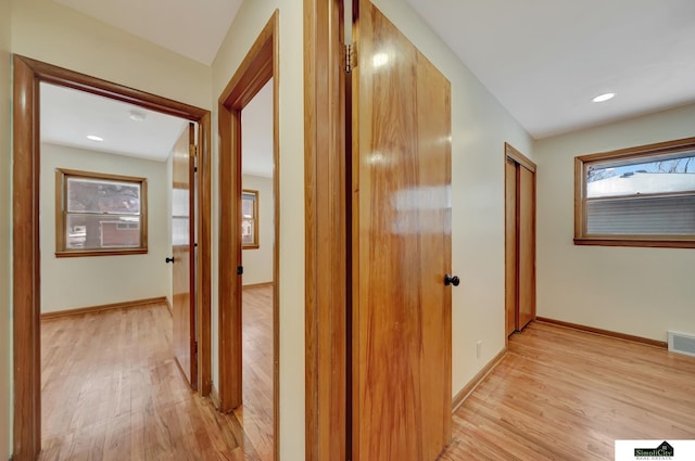 corridor with light hardwood / wood-style flooring