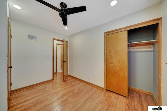 unfurnished bedroom with ceiling fan, a closet, and light hardwood / wood-style flooring