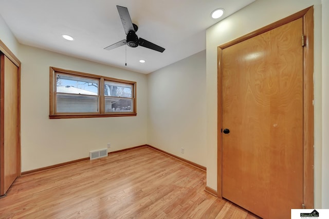 unfurnished bedroom with ceiling fan and light hardwood / wood-style flooring