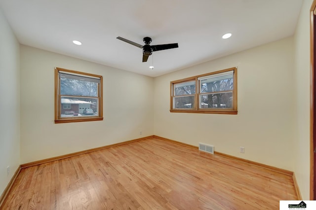 spare room featuring ceiling fan and light wood-type flooring