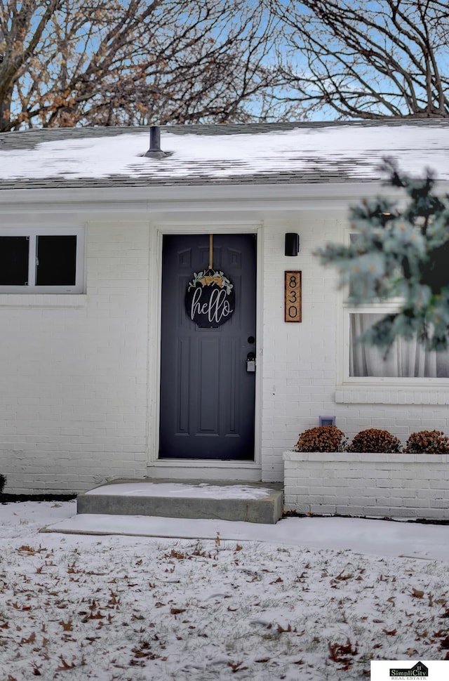 view of snow covered property entrance