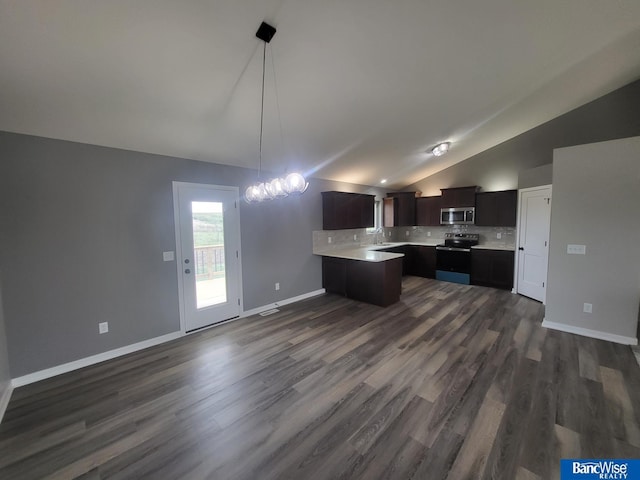 kitchen with sink, vaulted ceiling, appliances with stainless steel finishes, dark hardwood / wood-style floors, and decorative backsplash