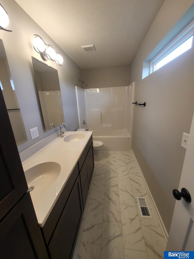 full bathroom with vanity, toilet, shower / bath combination, and a textured ceiling