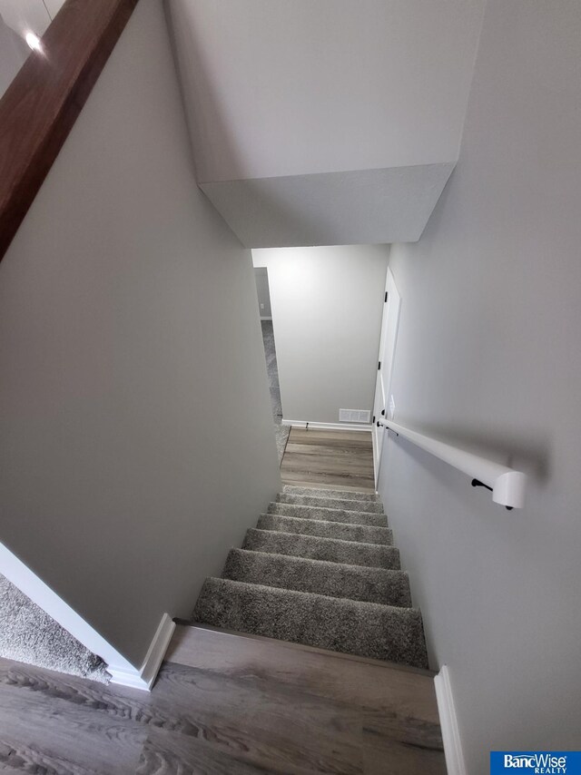 stairway featuring hardwood / wood-style flooring