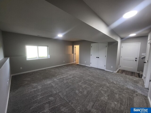 interior space featuring dark colored carpet