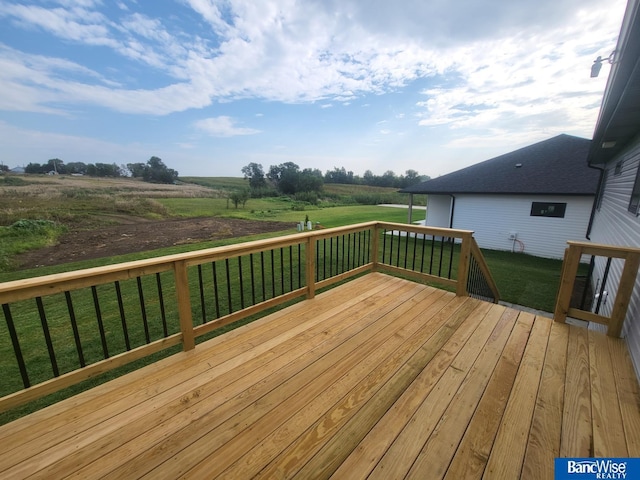 deck featuring a yard and a rural view