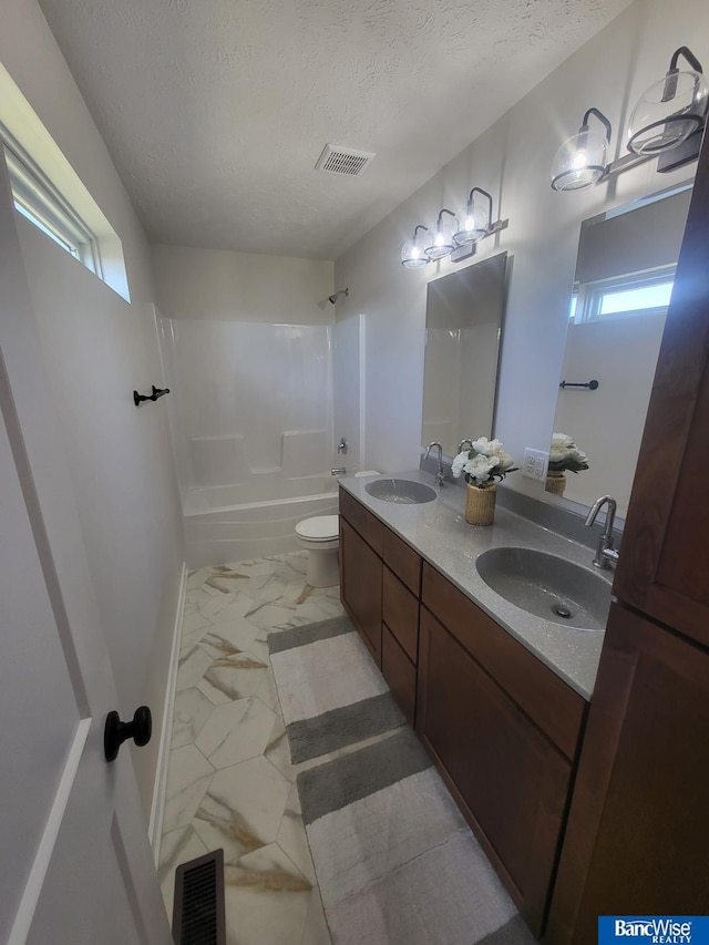 full bath with marble finish floor, visible vents, and a sink