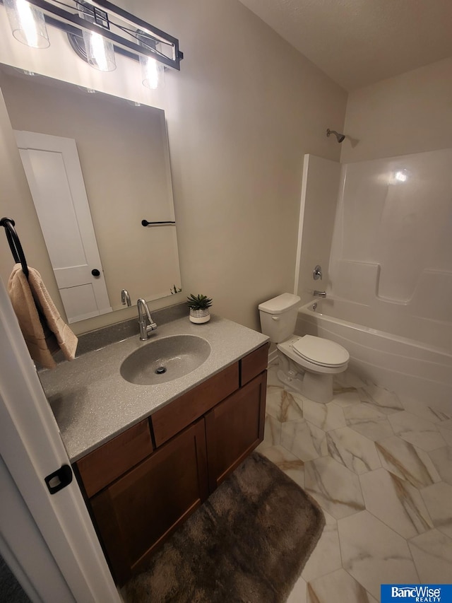 full bath featuring toilet, marble finish floor, vanity, and shower / bathtub combination