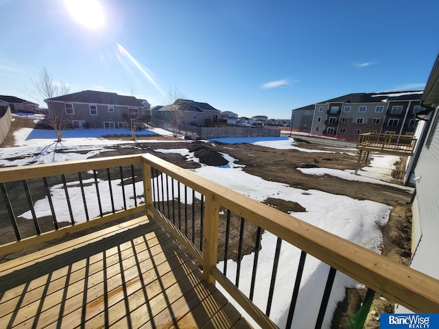 snow covered back of property with a residential view