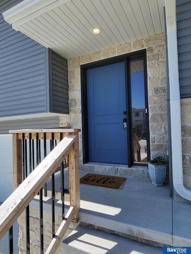 doorway to property with stone siding