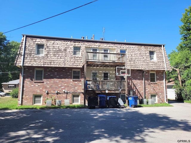 back of property with a balcony