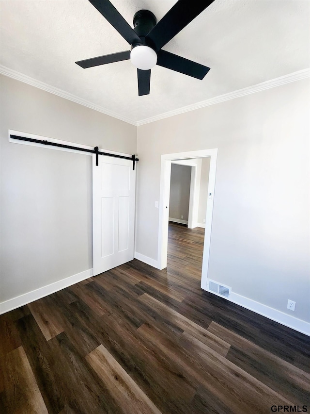 unfurnished bedroom with crown molding, dark hardwood / wood-style floors, ceiling fan, and a closet