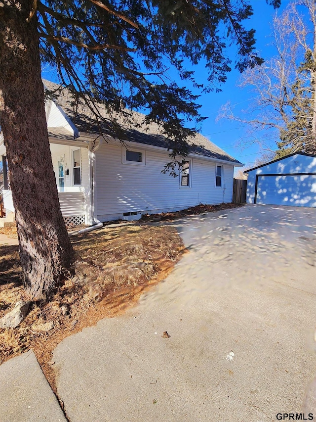 view of side of home with an outbuilding and a garage