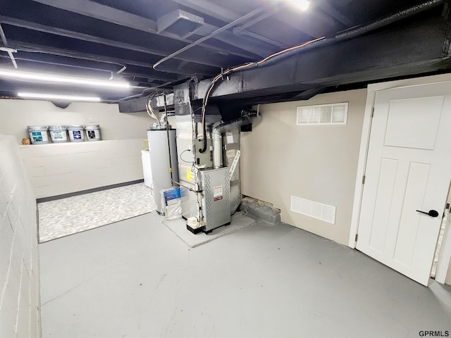 basement with water heater and heating unit