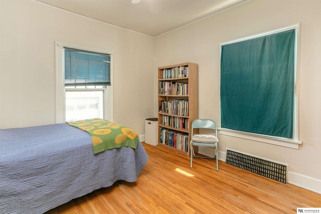 bedroom with visible vents and wood finished floors