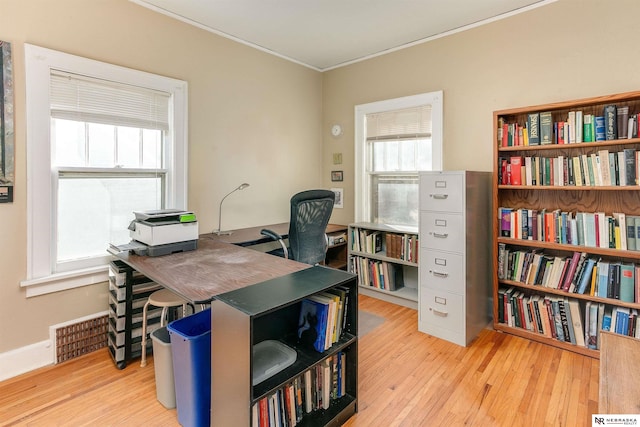 home office featuring visible vents, crown molding, and wood finished floors