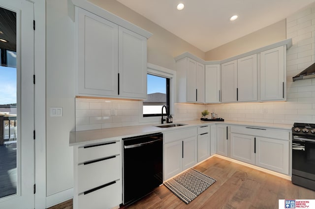 kitchen featuring sink, light hardwood / wood-style flooring, dishwasher, range with gas stovetop, and white cabinets