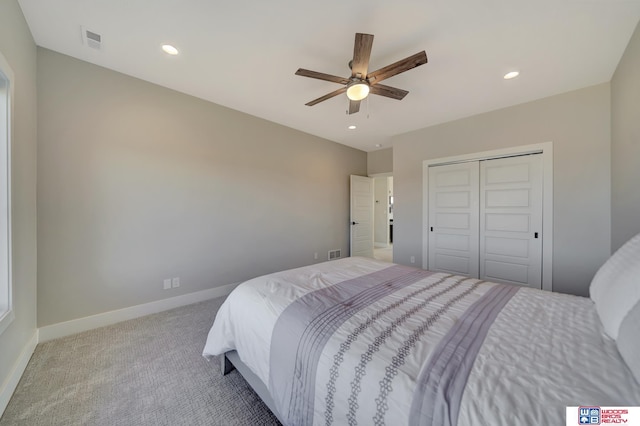 bedroom featuring ceiling fan, light carpet, and a closet