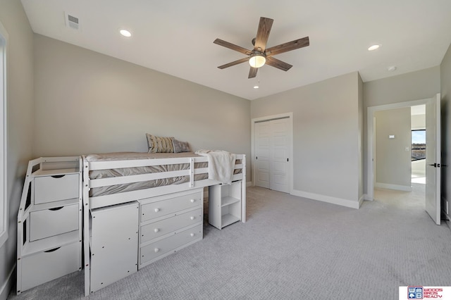 carpeted bedroom featuring a closet and ceiling fan