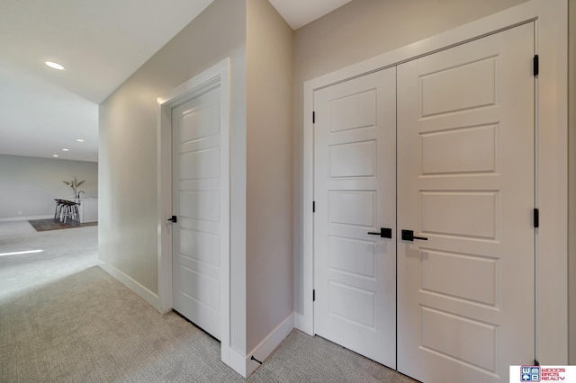 hall featuring light colored carpet