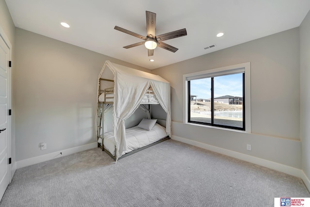 unfurnished bedroom with light carpet and ceiling fan