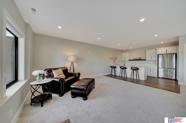 carpeted living room featuring a wealth of natural light