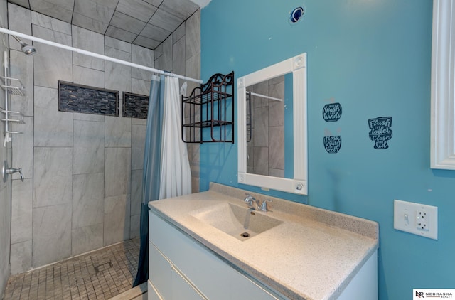 bathroom with walk in shower and vanity