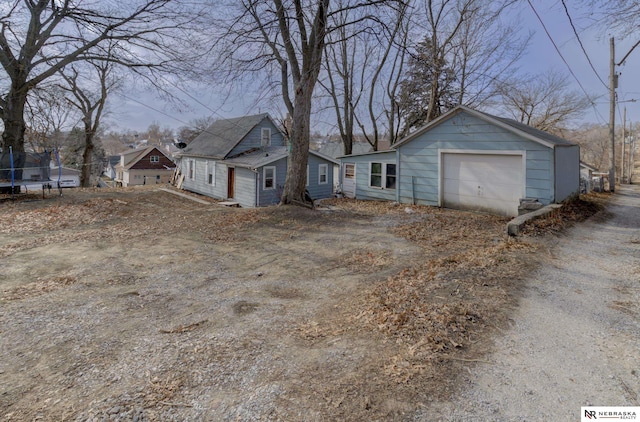 view of side of property featuring a trampoline and a garage