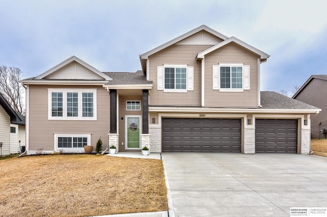 view of front of property with a garage and a front lawn