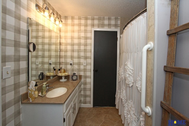 bathroom featuring vanity and a textured ceiling